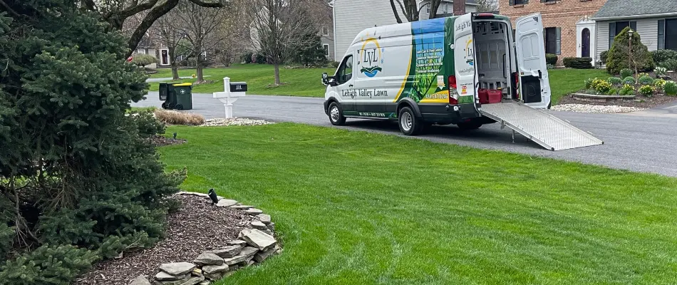 Lawn with work van in the street in Old Orchard, PA.
