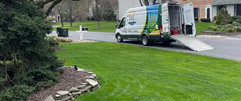 Lawn with work van in the street in Hellertown, PA.