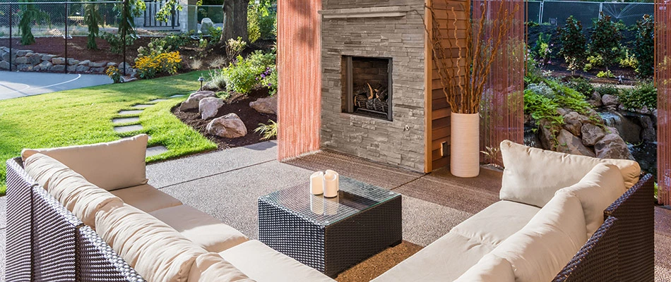An outdoor living space complete with couches and a fireplace in Emmaus, PA.